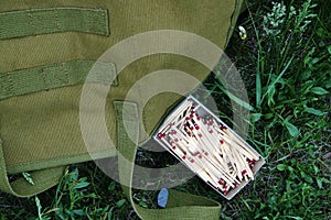 Box of Matches and Green Army Backpack Survival Wild Camping Nature Equipment Wilderness Outdoor Northern Forest