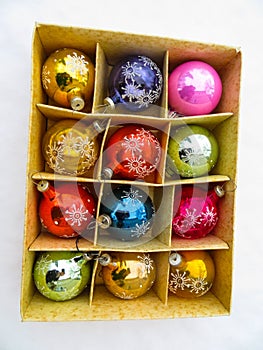Box with old christmas balls in the snow