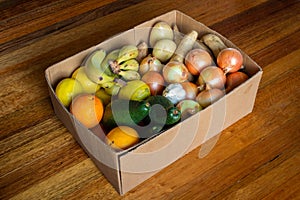 A box of organic fruits and vegetables at an angle.