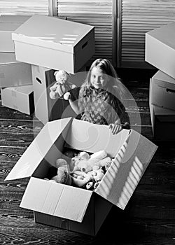 Box package and storage. Small child prepare toys for relocation. Kid girl relocating boxes background. Relocating