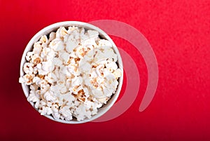 Box of popcorn on a red background, top view