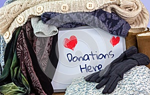 Box of pre loved clothes with sign Donations here sign