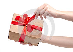 Box with red ribbon bow gift in hand