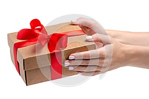 Box with red ribbon bow gift in hand