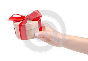Box with red ribbon bow gift in hand