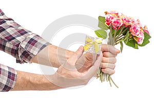 A box with a ring and flowers of a man`s hand