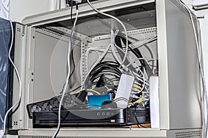 A box with routers and switches and a lot of cables. Electronic equipment