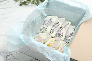 Box with scented sachets on white marble table