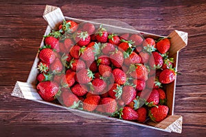 A box of strawberries on a wooden table