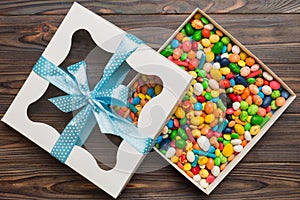 Box with sweet chocolate candies on color background, Various candy sweets. Valentines day gift box. Top view flat lay