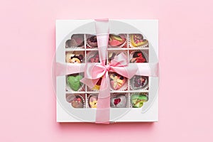 Box with sweet chocolate candies on color background, Various candy sweets. Valentines day gift box. Top view flat lay