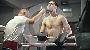 Box training - a tired man rinsing his mouth and spits in the trash can