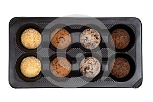 Box of truffle chocolates isolated on white. Top view