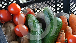 Box with vegetables potatoes beets cucumbers cherry tomatoes cabbage onions carrot close up. Food delivery services