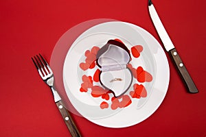 Box witha ring, table setting on a red background. Concept Valentine`s Day. - Image photo
