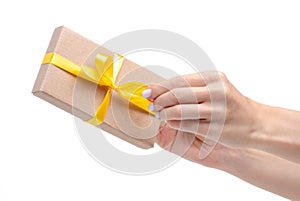 Box with yellow ribbon bow gift in hand