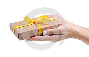 Box with yellow ribbon bow gift in hand