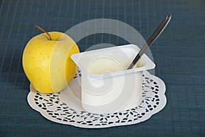 Box with yogurt, apple and a napkin
