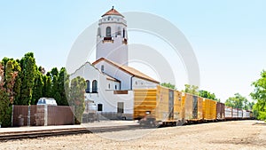 Boxcars on a freight train pass the Boise Train depot