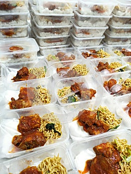 boxed rice merchandise containing white rice, noodles, fried vegetables, and Balinese tofu chicken