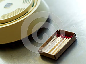 Boxed wooden matches and smoke detector photo