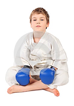 Boxer boy in white dress and blue boxing gloves