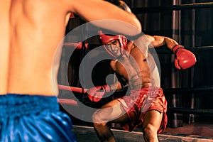 Boxer fighter with boxing helmet in fierce and intense fight. Impetus