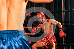 Boxer fighter with boxing helmet in fierce and intense fight. Impetus