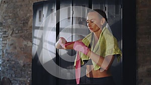 Boxer in Focused Hand Wrapping Ritual, Gearing Up for the Ring