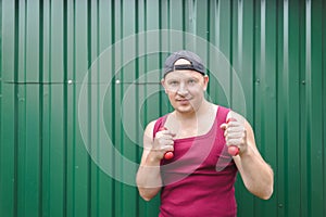 Boxer guy working out with dumbbells