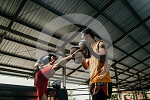 boxer and his coach doing some sparring in ring