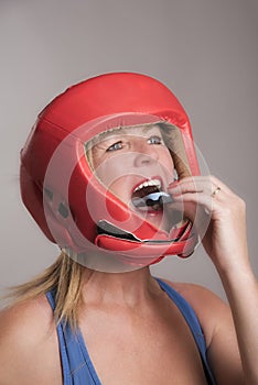 Boxer inserting a gum shield into the mouth