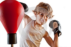 Boxer kid training with punching ball