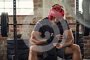 Boxer man wrapping his hands with gloves