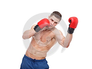 A boxer, with a muscular naked torso, makes a blow from below. Isolated.