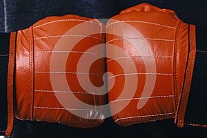 Boxer presses hands together. Athletes hands in leather gloves
