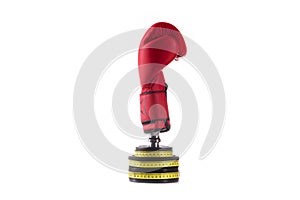 Boxer protective red glove on lifting weights wrapped with yellow measurment tape on white background