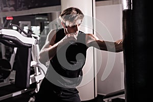 Boxer With Punch Bag In Action - A Man With A Tattoo In Red Boxing Gloves - Boxing