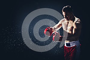 Boxer punching his gloves against each other