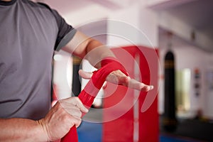Boxer putting handwraps on