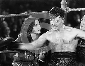 Boxer sitting in the corner of a boxing ring