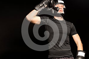 Boxer standing raising his fist to his head