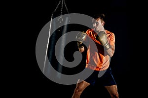 Boxer throws punches in the gym while training