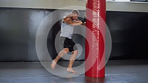 Boxer training gym punching bag Man kickboxer boxing, workout indoor. Cardio exercising preparing for fight.