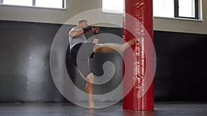 Boxer training gym punching bag Man kickboxer boxing, workout indoor. Cardio exercising preparing for fight.