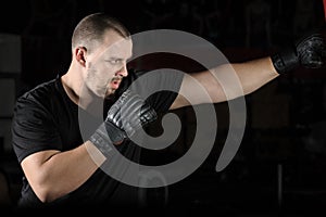 Boxer training on a punching bag in the gym