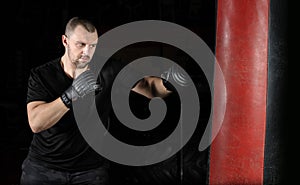 Boxer training on a punching bag in the gym