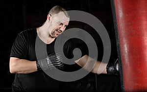 Boxer training on a punching bag in the gym