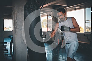 Boxer training on a punching bag in the gym