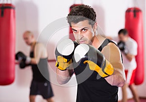 boxer trains in kickboxing gloves